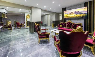 a lobby with chairs and a painting on the wall at Golden Bazaar Hotel in Istanbul