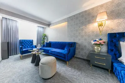 a living room with blue furniture and a blue couch at Golden Bazaar Hotel in Istanbul