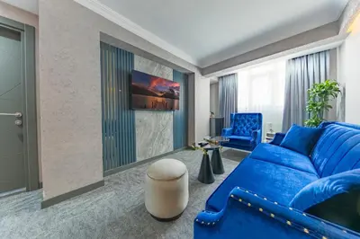 a living room with a blue couch and blue chairs at Golden Bazaar Hotel in Istanbul
