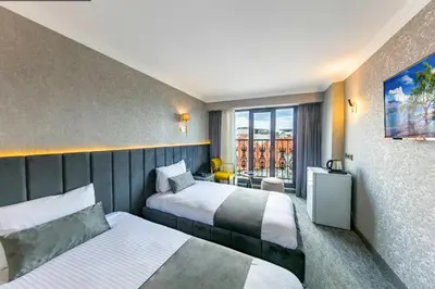a hotel room with two beds and a window at Golden Bazaar Hotel in Istanbul
