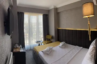 a hotel room with a bed and a window at Golden Bazaar Hotel in Istanbul