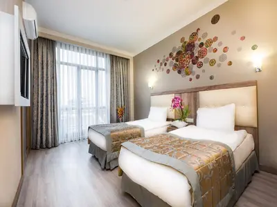 a hotel room with two beds and a tv at Fatih Hotel Corner in Istanbul