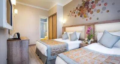 a hotel room with two beds and a television at Fatih Hotel Corner in Istanbul