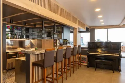 a bar with a bar stools and a piano at Metro Hotel in Istanbul