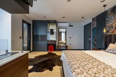 a bedroom with a king sized bed and a sink at La Miel Şile in Sile