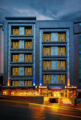 an apartment building with a building at night at Orya Hotel in Istanbul