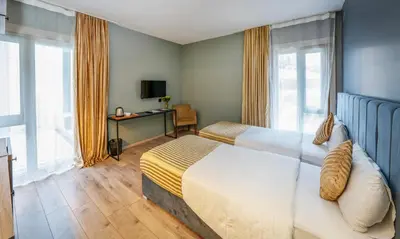 a hotel room with a bed and a desk and window at Orya Hotel in Istanbul