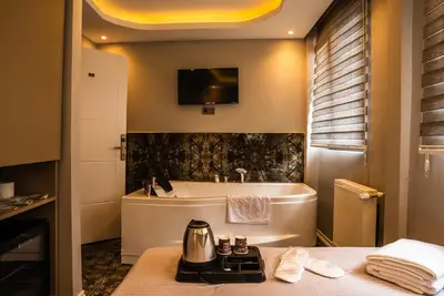 a bathroom with a tub and a sink at CK PALACE Hotel in Istanbul