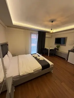 a bedroom with a large bed and a living room at Taksim Nova homes in Istanbul