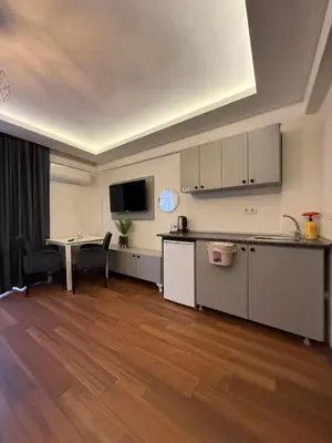 a kitchen with white cabinets and a table and chairs at Taksim Nova homes in Istanbul