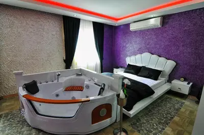 a bedroom with a bed with a tub in it at Ag Şişli Hotel in Istanbul