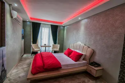 a bedroom with a bed with red pillows on it at Ag Şişli Hotel in Istanbul