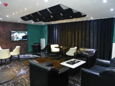a lobby with couches and chairs and a tv at Ag Şişli Hotel in Istanbul