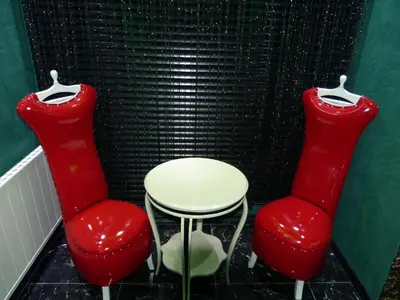 two red chairs and a white table in a room at Ag Şişli Hotel in Istanbul