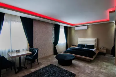 a bedroom with a bed and a red stripe on the ceiling at Ag Şişli Hotel in Istanbul