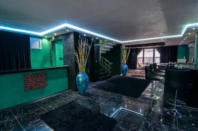 a lobby with blue vases and a bar with chairs at Ag Şişli Hotel in Istanbul