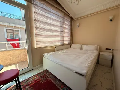 a small bedroom with a bed and a window at IQ Hotel in Istanbul
