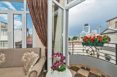 a balcony with a couch and a window with flowers at IQ Hotel in Istanbul