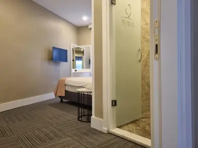 a door to a room with a bed and a bathroom at Mia Berre Hotels in Istanbul