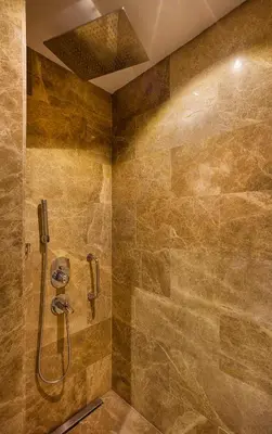 a bathroom with a shower with a stone wall at Hilton Garden Inn Kocaeli Sekerpinar in Şekerpınarı