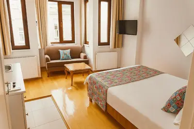 a hotel room with a bed and a chair at Istanberry - Vanilla Apartments in Istanbul