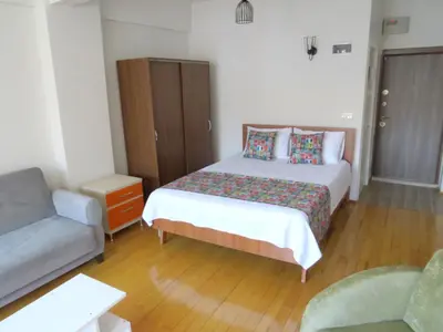 a small bedroom with a bed and a couch at Istanberry - Vanilla Apartments in Istanbul