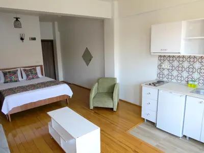 a hotel room with a bed and a chair at Istanberry - Vanilla Apartments in Istanbul