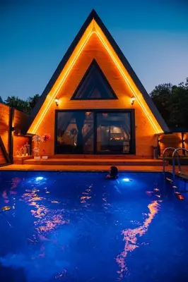 a house with a swimming pool in front of it at Ginza Bungalov Sapanca in Sapanca