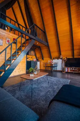 a living room with a staircase and a table at Ginza Bungalov Sapanca in Sapanca