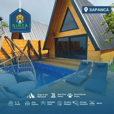 a villa with a swimming pool next to a house at Ginza Bungalov Sapanca in Sapanca