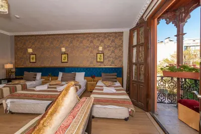 a hotel room with four beds and a balcony at İSTA PALACE-GRAND BAZAAR in Istanbul