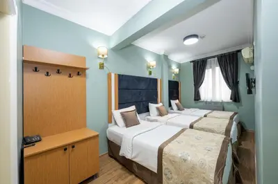 two beds in a room with blue walls at İSTA PALACE-GRAND BAZAAR in Istanbul