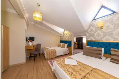 a hotel room with a bed and a desk at İSTA PALACE-GRAND BAZAAR in Istanbul