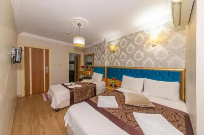 a hotel room with two beds and a room with at İSTA PALACE-GRAND BAZAAR in Istanbul