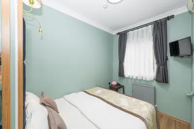 a small bedroom with a bed and a window at İSTA PALACE-GRAND BAZAAR in Istanbul