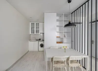 a white dining room with a white table and chairs at Private Modern 2BR1Bath Bebek Gem! #80 in Istanbul