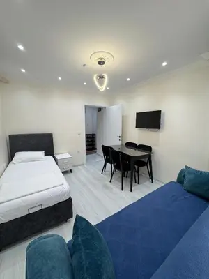 a hotel room with a bed and a dining room at CEM Apart in Istanbul