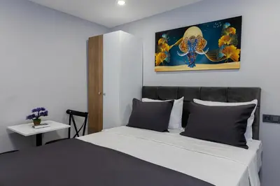 a bedroom with a bed and a painting on the wall at Aya Langa Guest House in Istanbul