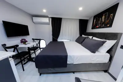 a bedroom with a bed and a table and a desk at Aya Langa Guest House in Istanbul