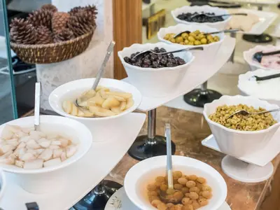 a buffet with bowls of different types of food at MidMar Deluxe Hotel in Istanbul