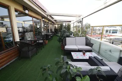 a balcony with chairs and tables on a building at MidMar Deluxe Hotel in Istanbul