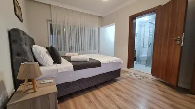 a hotel room with a bed and a bathroom at Cozy Spacious near Green Mosque in Yıldırım