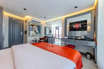a bedroom with a large bed and a television at Atar Airport Hotel - Restaurant & Spa Wellness in Arnavutköy