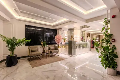 a lobby with chairs and plants in a building at Atar Airport Hotel - Restaurant & Spa Wellness in Arnavutköy