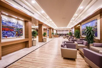 a lobby of a hospital with chairs and plants at Gorrion Hotel Istanbul in Istanbul