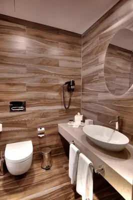 a bathroom with a sink and a toilet and a mirror at Gorrion Hotel Istanbul in Istanbul