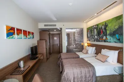 a hotel room with two beds and a television at Gorrion Hotel Istanbul in Istanbul