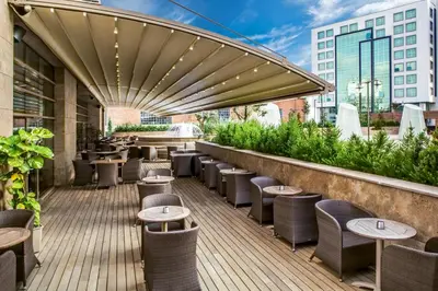 a patio with tables and chairs on a building at Gorrion Hotel Istanbul in Istanbul