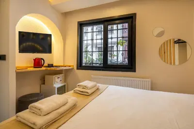 a bedroom with a bed with two towels on it at Emir Hotel in Istanbul
