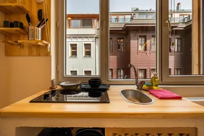 a kitchen counter with a sink and a window at Emir Hotel in Istanbul
